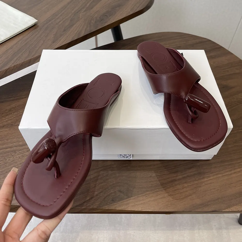 Top view showing burnt red leather and flat sole of Loewe sandal