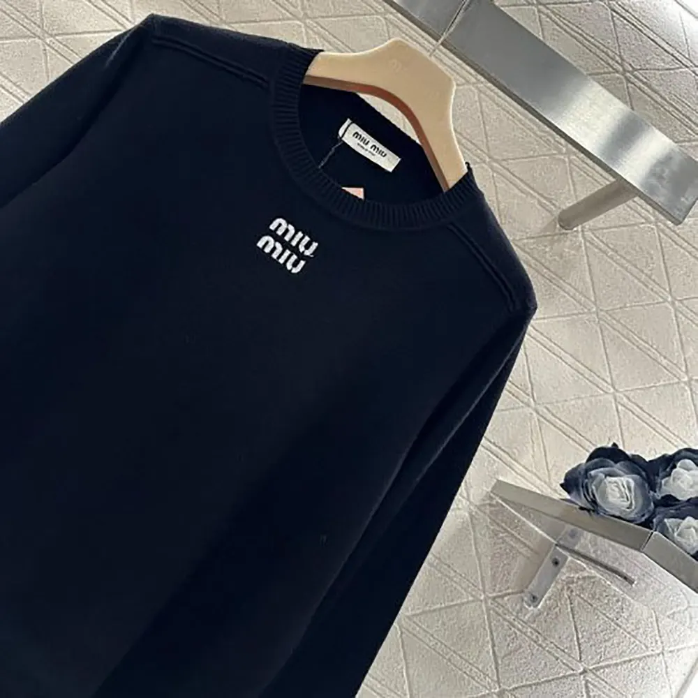 Side profile showcasing relaxed fit of Miu Miu Women Cashmere Crew-Neck Sweater-Black