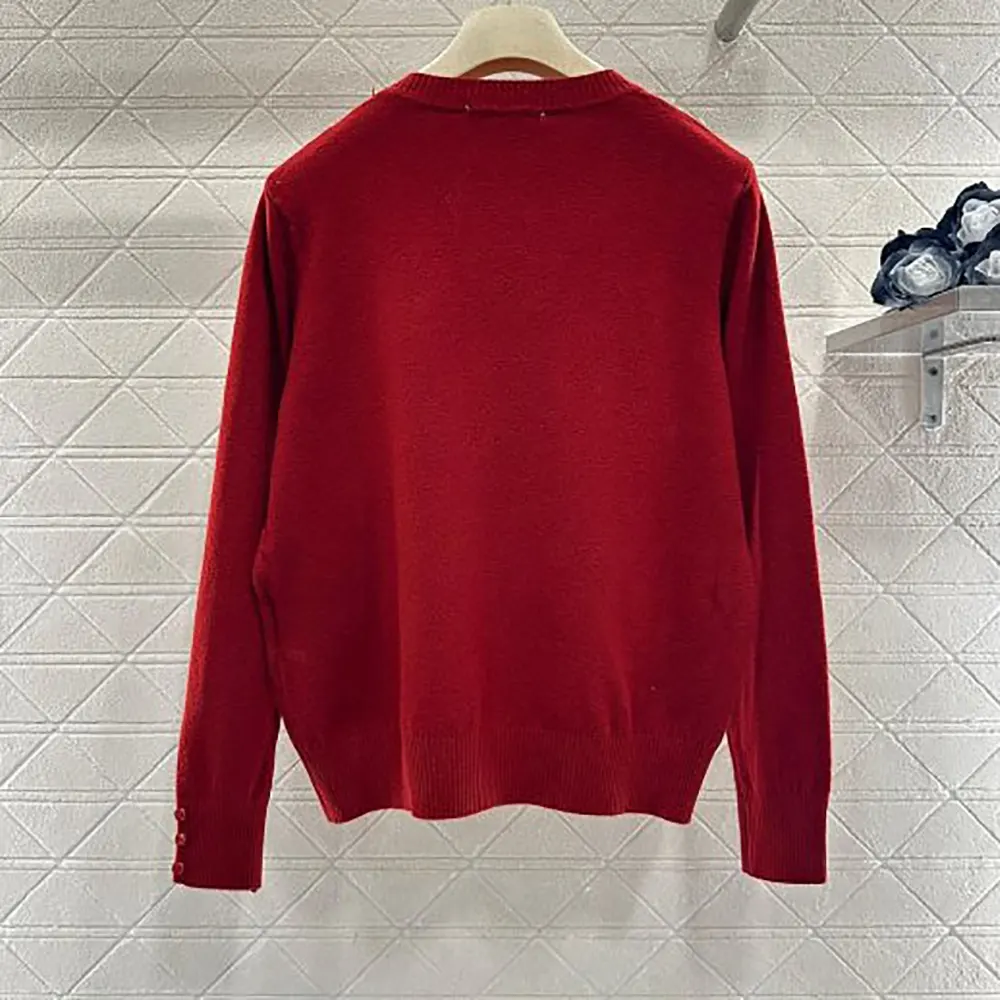Close-up detail of ribbed cuff on Miu Miu red cashmere sweater