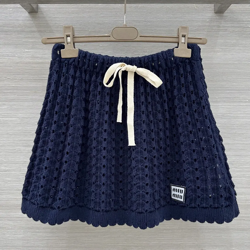 Close-up of Miu Miu Women Cotton Miniskirt-Nvay metallic logo detail