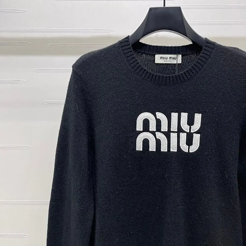 Side angle showing relaxed silhouette of Miu Miu Women Double Cashmere Sweater