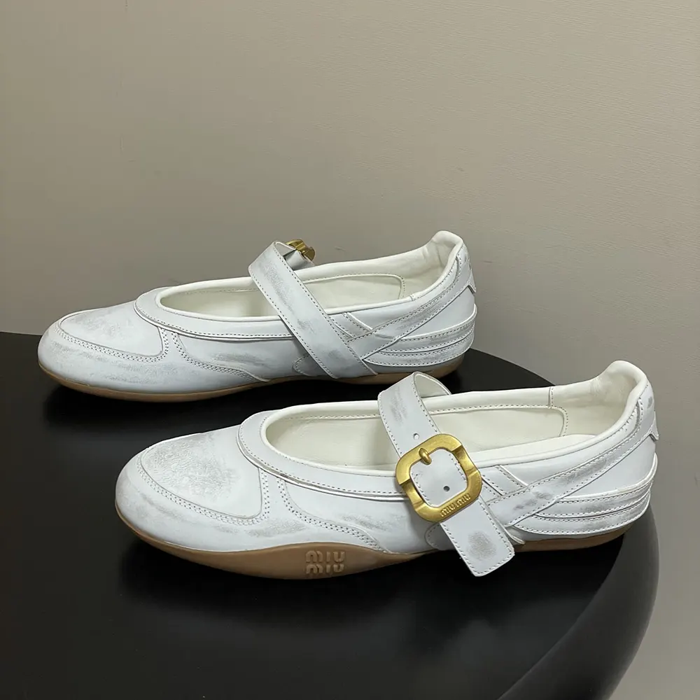 Top angle showing rounded toe and leather texture of Miu Miu ballerinas
