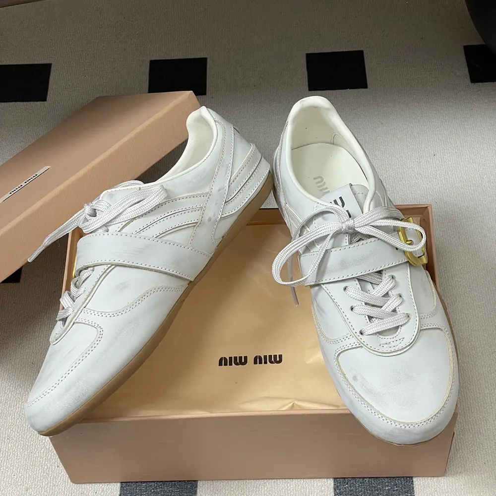 Overhead view showing white leather and low-top silhouette of Miu Miu Women Gymnasium Sneakers