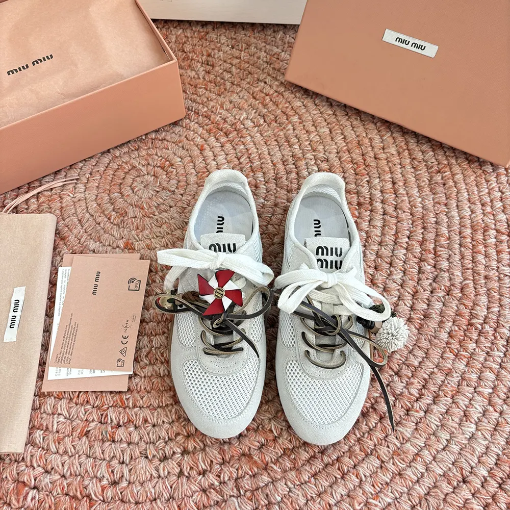 Close-up of white mesh and suede details on Miu Miu sneakers
