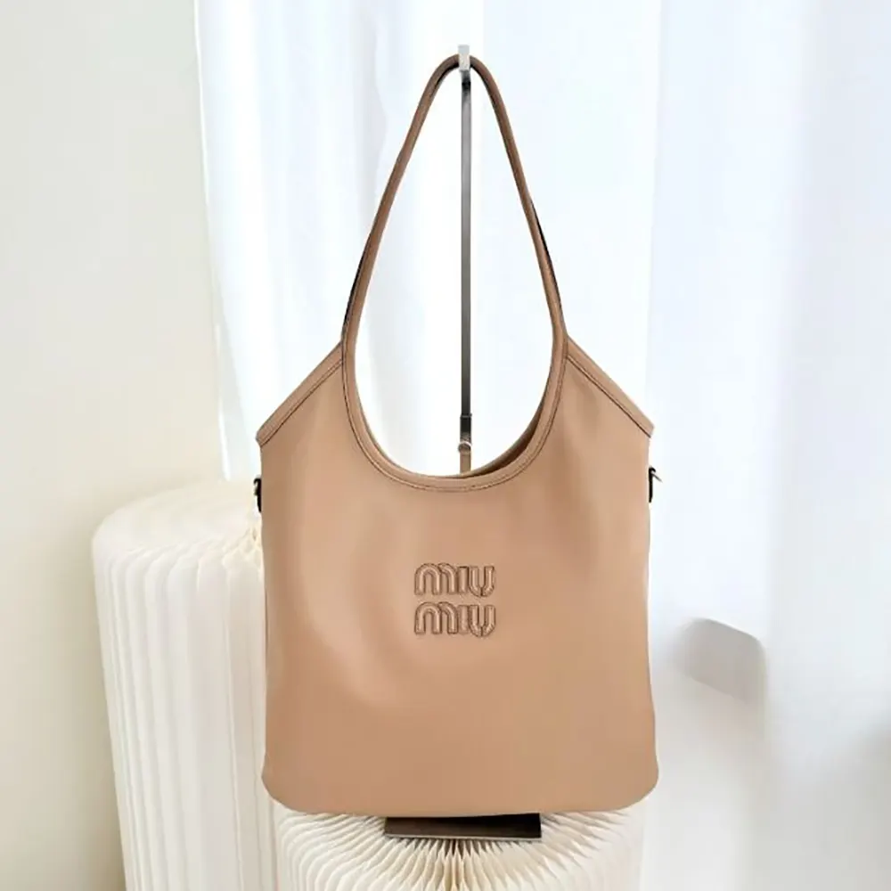 Close-up of sandy leather and silver lettering on Miu Miu Women IVY Bag