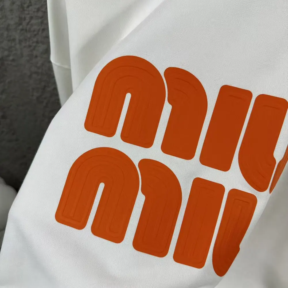 Side angle showing relaxed fit of Miu Miu Women Logo-Embroidered Sweatshirt