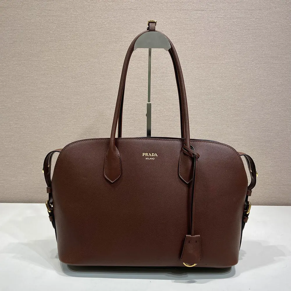 Close-up of gold-tone hardware on Prada Women Large Leather Tote Bag-Dark Brown