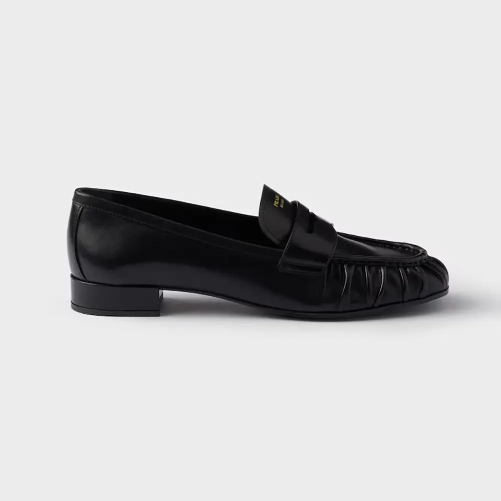 Side profile of Prada Women Leather Loafers-Black showing sleek silhouette