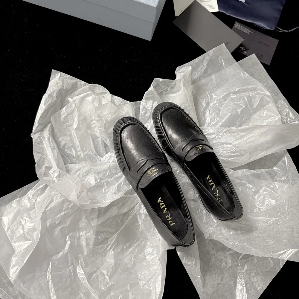 Close-up of silver-tone hardware on Prada Women Leather Loafers-Black