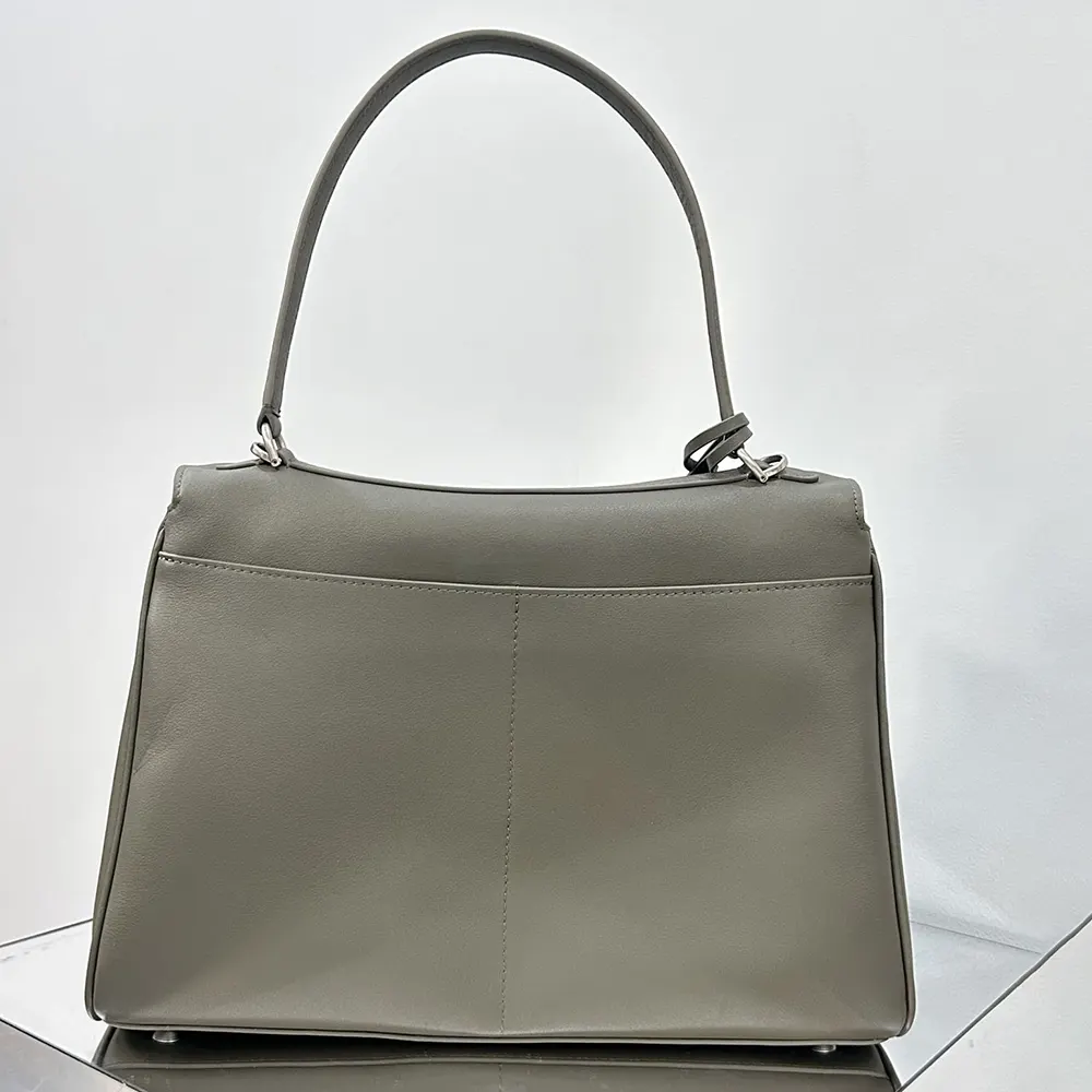 Side angle showing silhouette and strap of Balenciaga Women Rodeo Handbag Medium