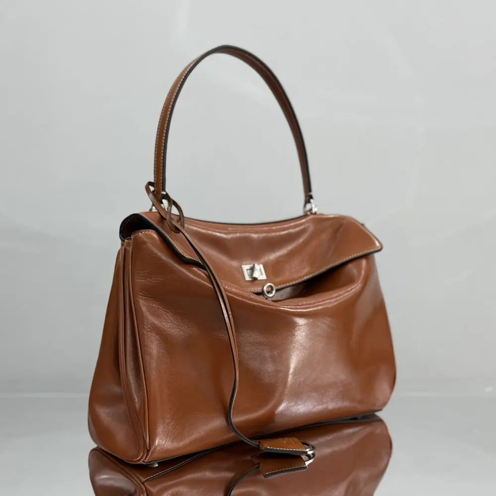 Side angle showing silhouette of Balenciaga Women Rodeo Handbag Medium tan