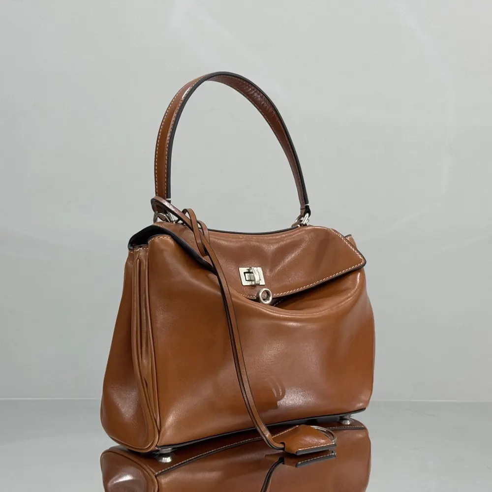 Side angle showing silhouette of Balenciaga Women Rodeo Handbag Small tan bag