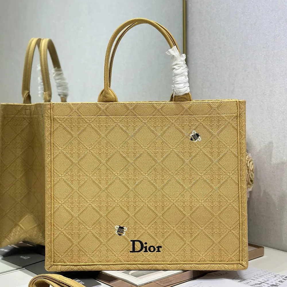 Close-up detail of Cannage embroidery on natural raffia-effect tote by Dior