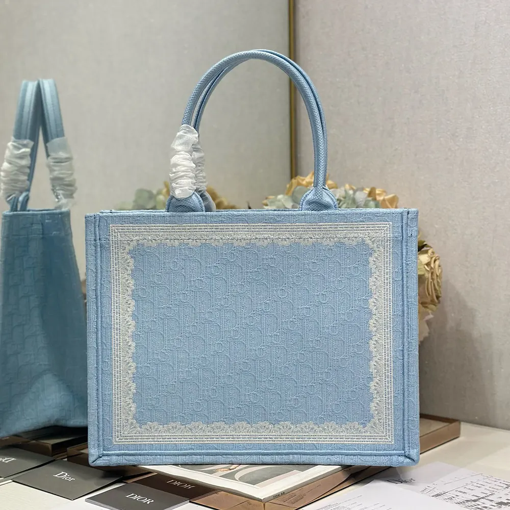 Side angle of Dior Women Medium Dior Book Tote highlighting Dior Médaillon charm