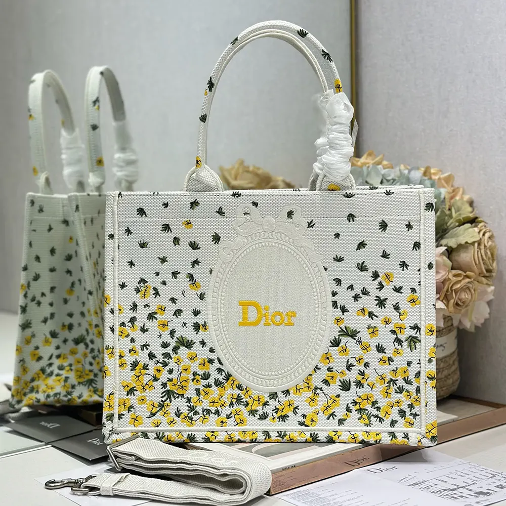 Close-up of buttercup Dior embroidery and white Dior Médaillon detail