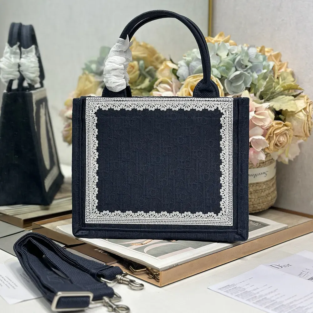 Side angle showing adjustable strap and silhouette of Small Dior Book Tote