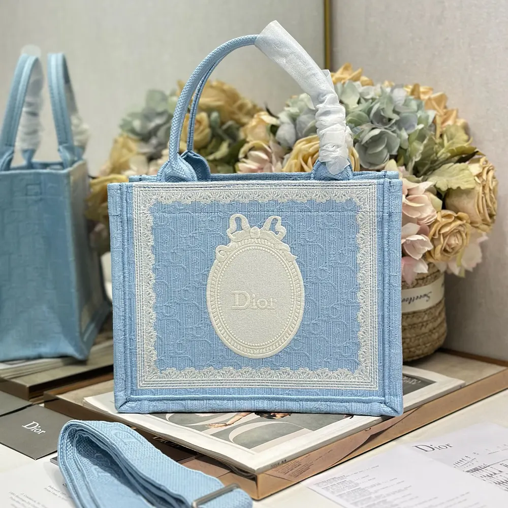 Close-up of white lace and Dior Médaillon on Small Dior Book Tote