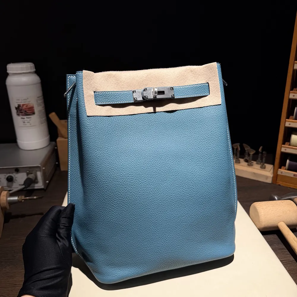Close-up of blue Togo leather texture with palladium hardware detail