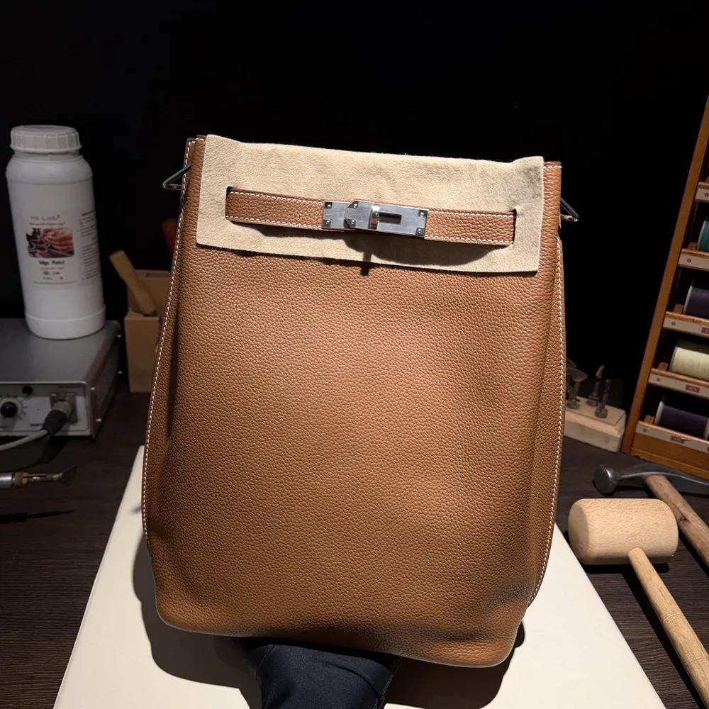 Side angle showing texture of brown Togo leather on Kelly 22 bag