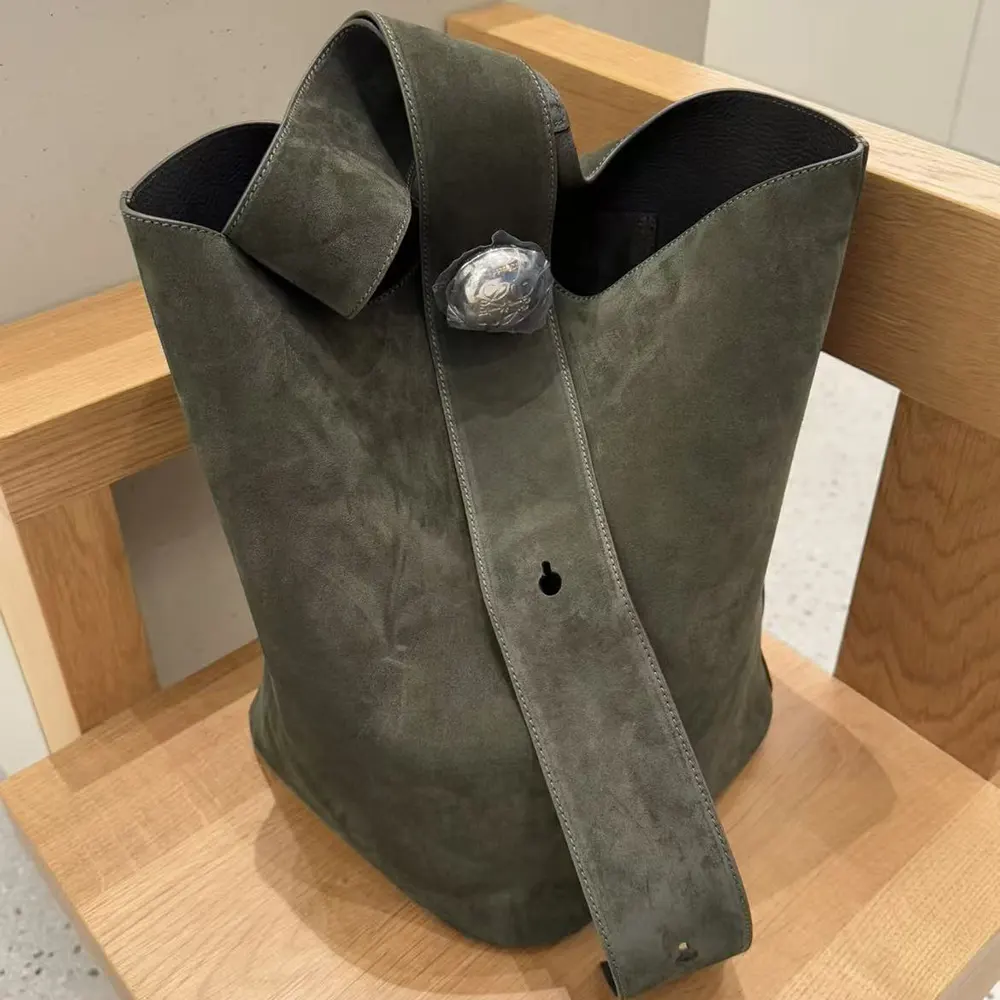 Side profile showing silhouette and adjustable strap on Loewe Large Pebble Bucket Bag