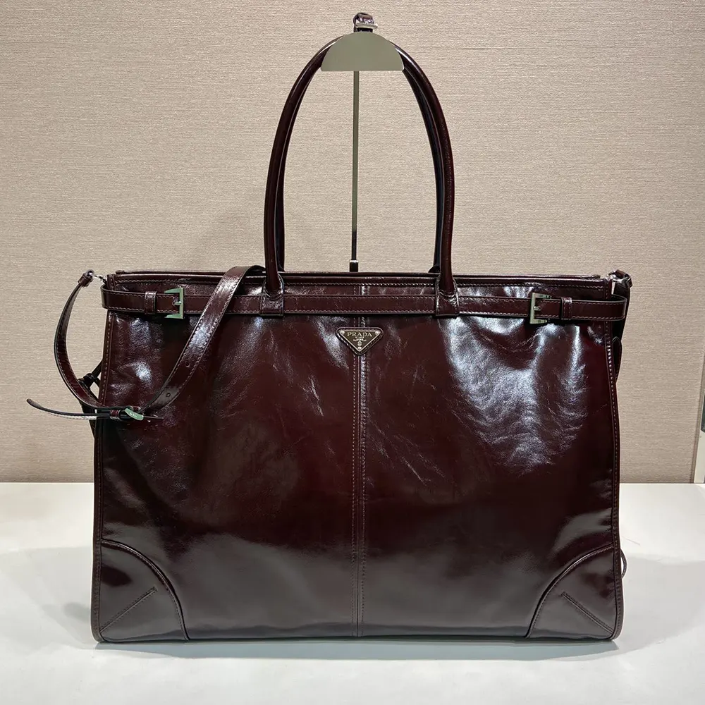 Close-up on polished hardware and magnetic closure on Prada tote