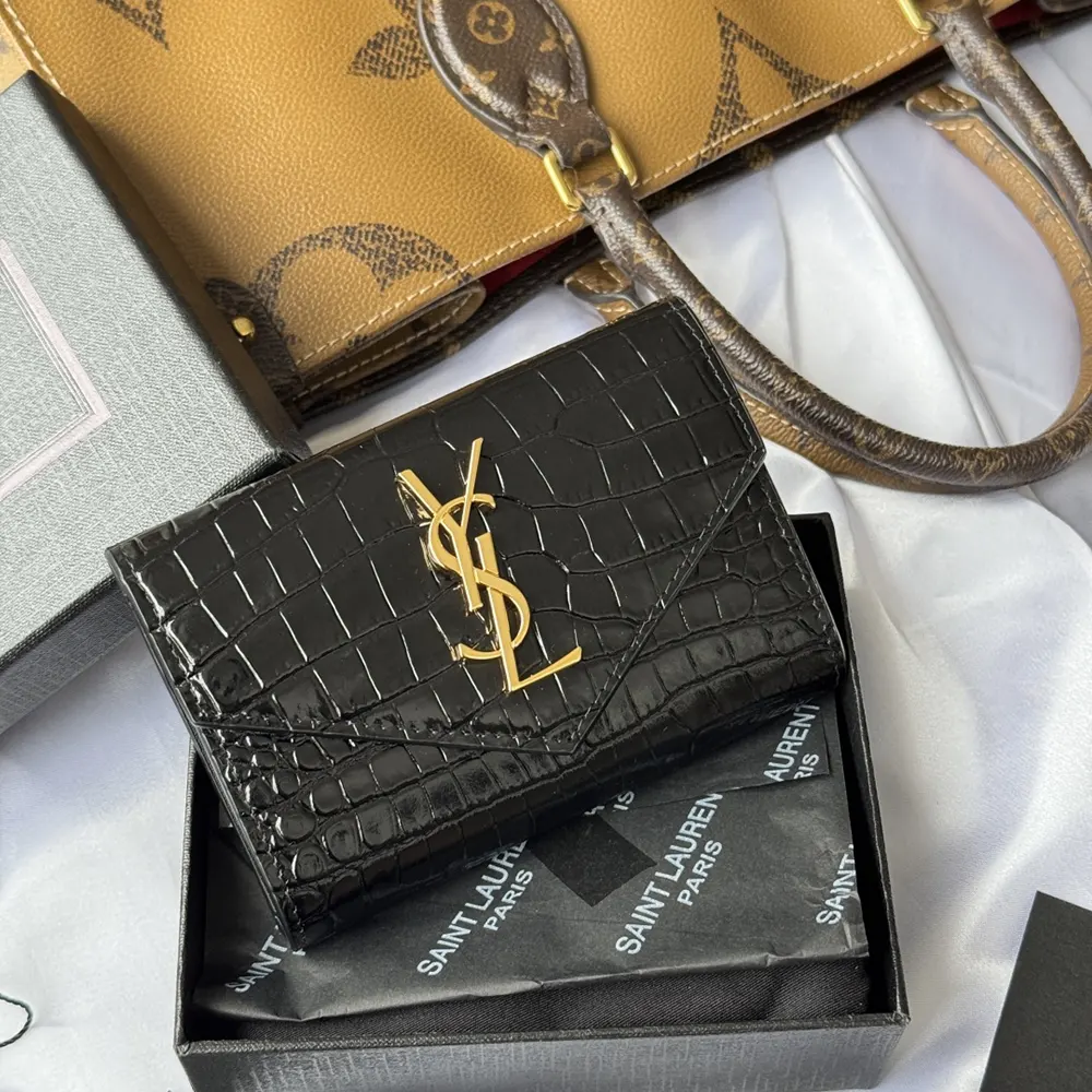 Side angle showing flap closure and slim silhouette of Saint Laurent YSL card case