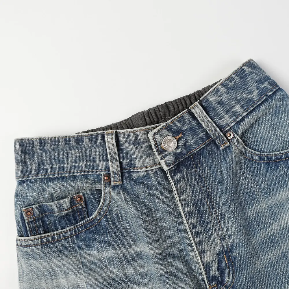 Close-up of button and zip closure on Balenciaga baggy pants
