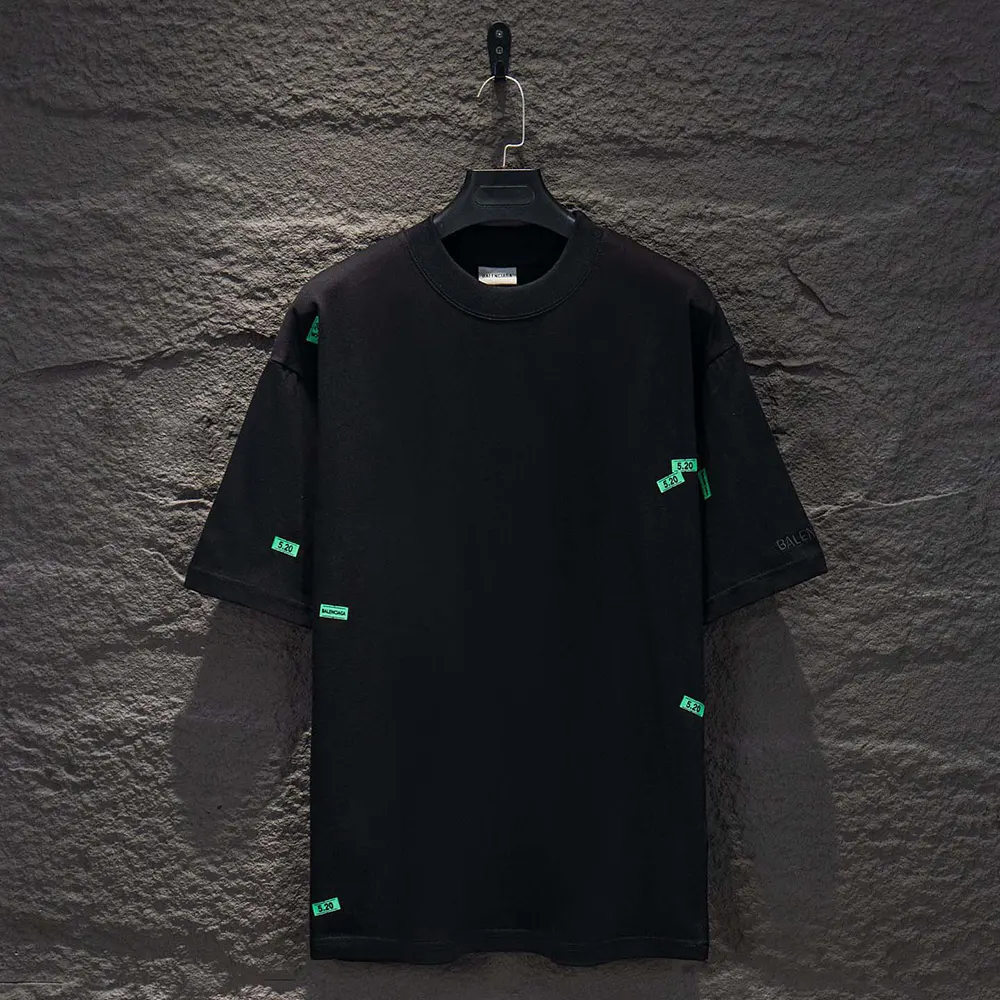 Close-up of green sticker graphics on Balenciaga Men 520 T-Shirt