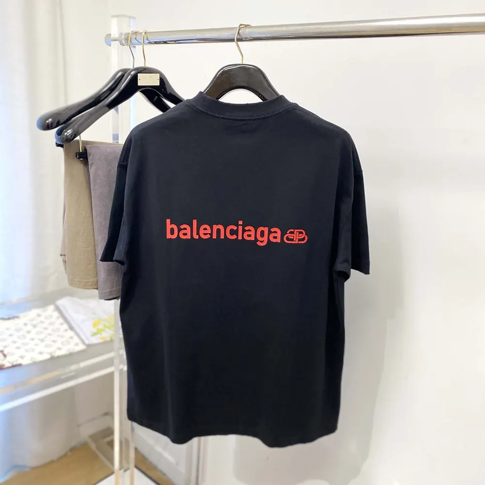 Close-up detail of faded black fabric and red accents on Balenciaga t-shirt