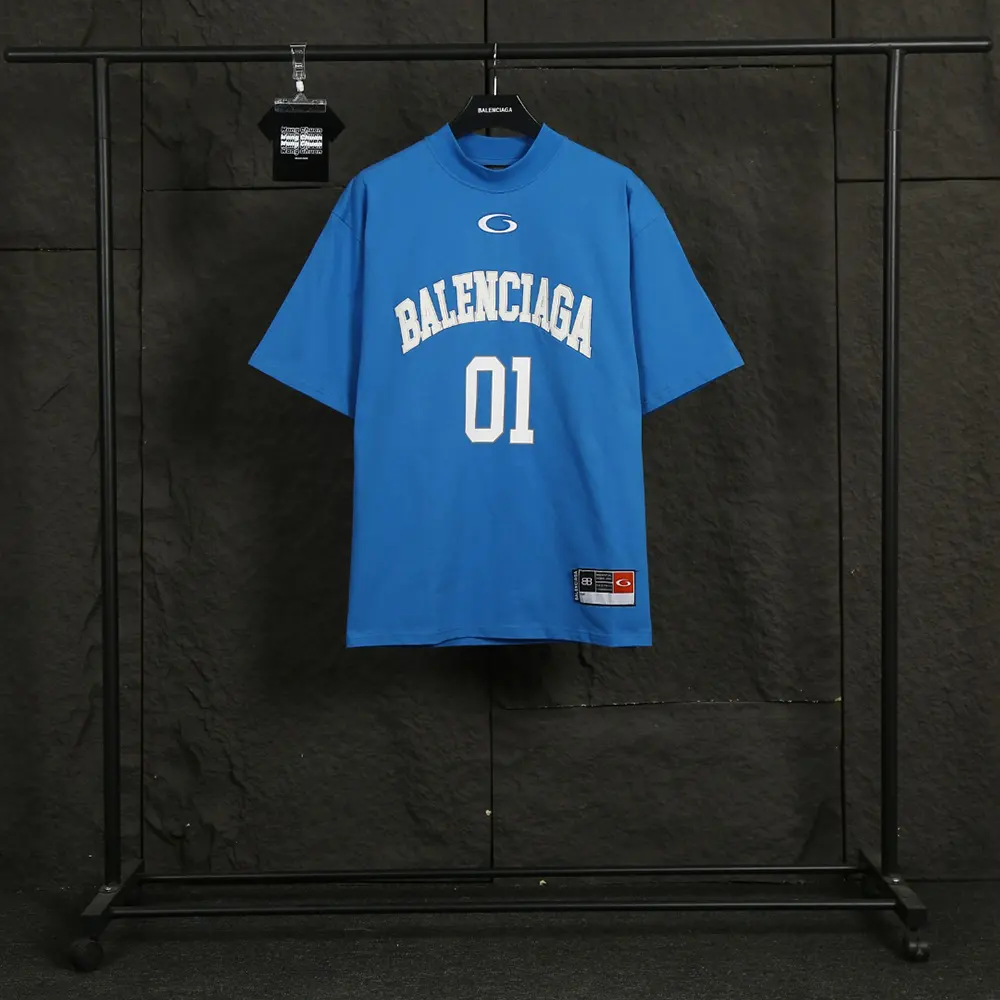 Close-up of washed blue fabric and Balenciaga logo detail on oversized t-shirt