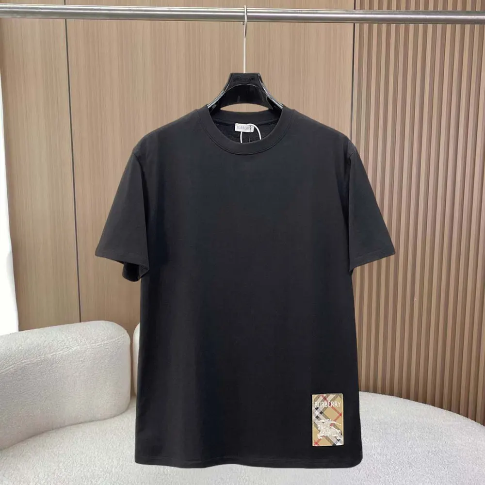 Close-up of Burberry check label detail on black cotton T-shirt sleeve