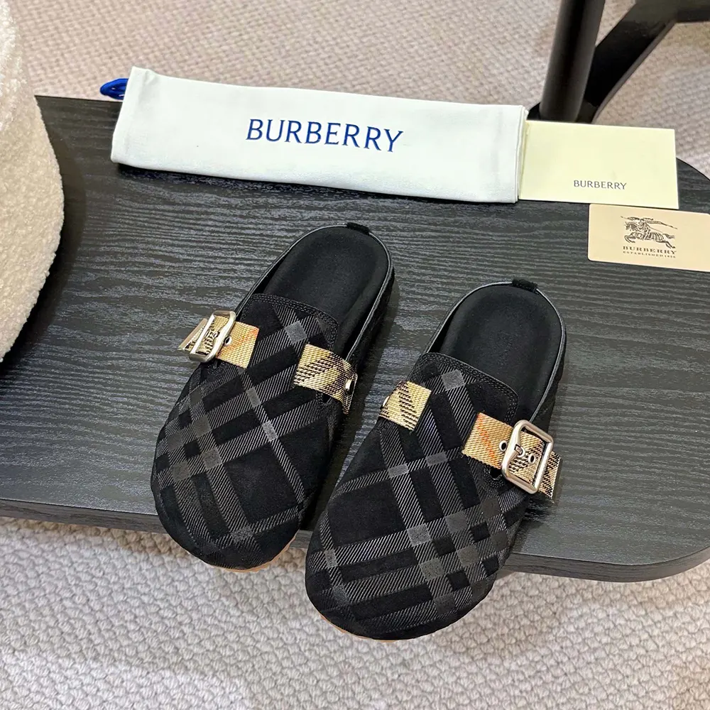 Close-up of signature Burberry check detail on black denim clogs