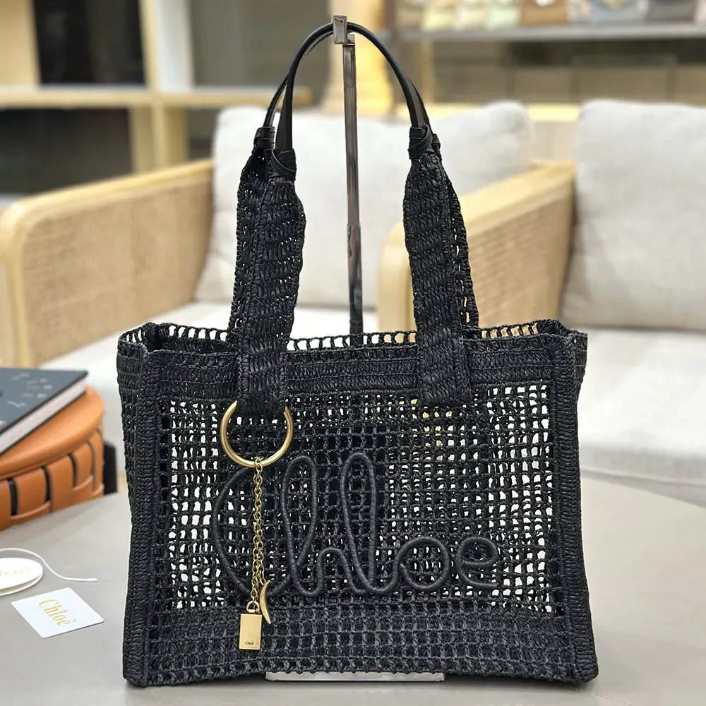 Close-up on black buffalo leather trim and gold hardware on Chloe Summer Banana tote