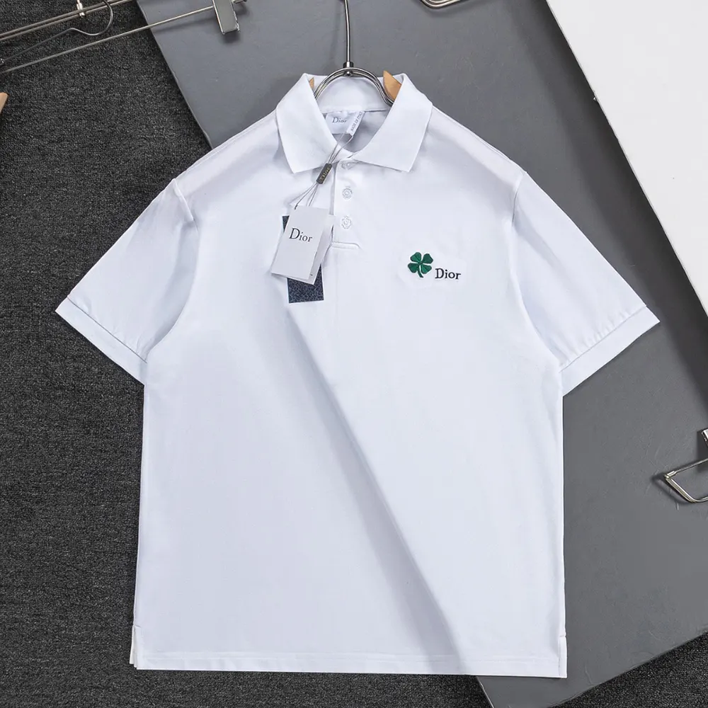 Close-up of Dior clover embroidery on white cotton piqué polo shirt