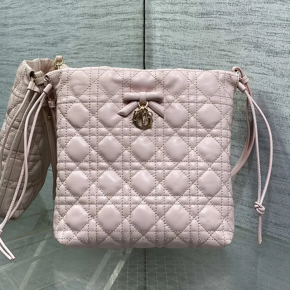Close-up of silver-tone Cannage hardware on pink lambskin bucket bag