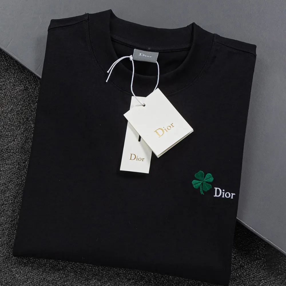 Close-up detail of Dior clover embroidery on black cotton jersey tee