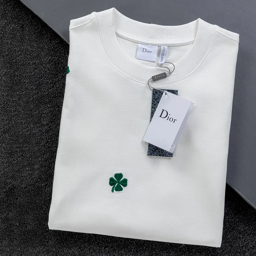 Close-up of Dior Clover embroidery detail on white cotton jersey T-shirt