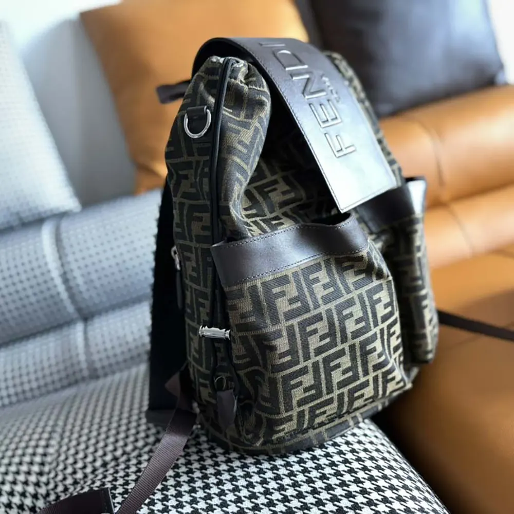 Side angle showing adjustable straps on Fendi Men Strike backpack