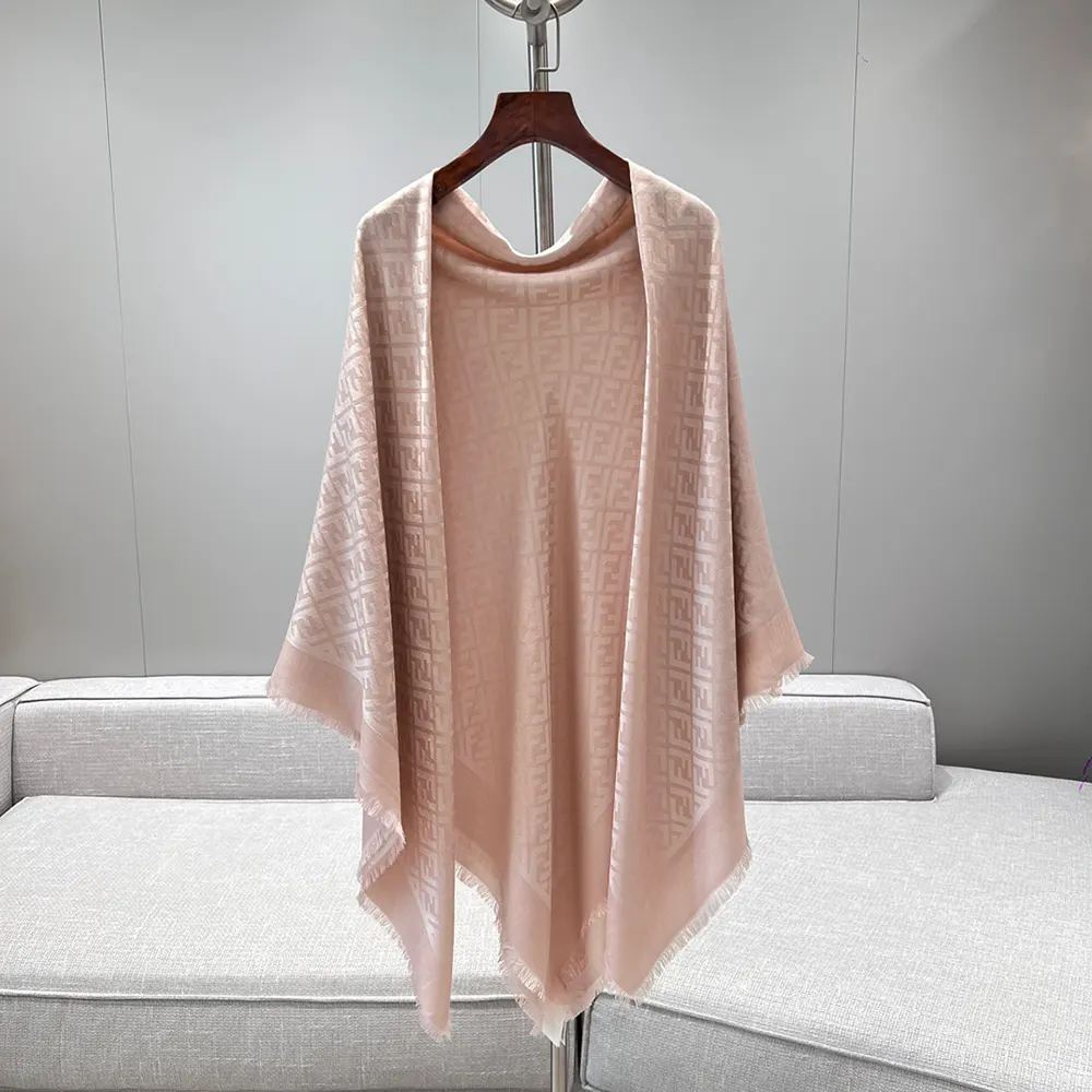 Close-up detail of Fendi FF logo on pink organic silk shawl