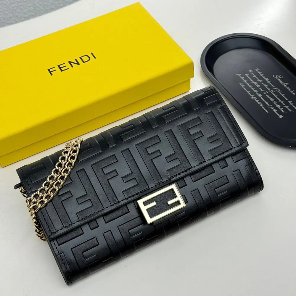 Close-up detail of gold chain and clasp on Fendi black nappa leather wallet