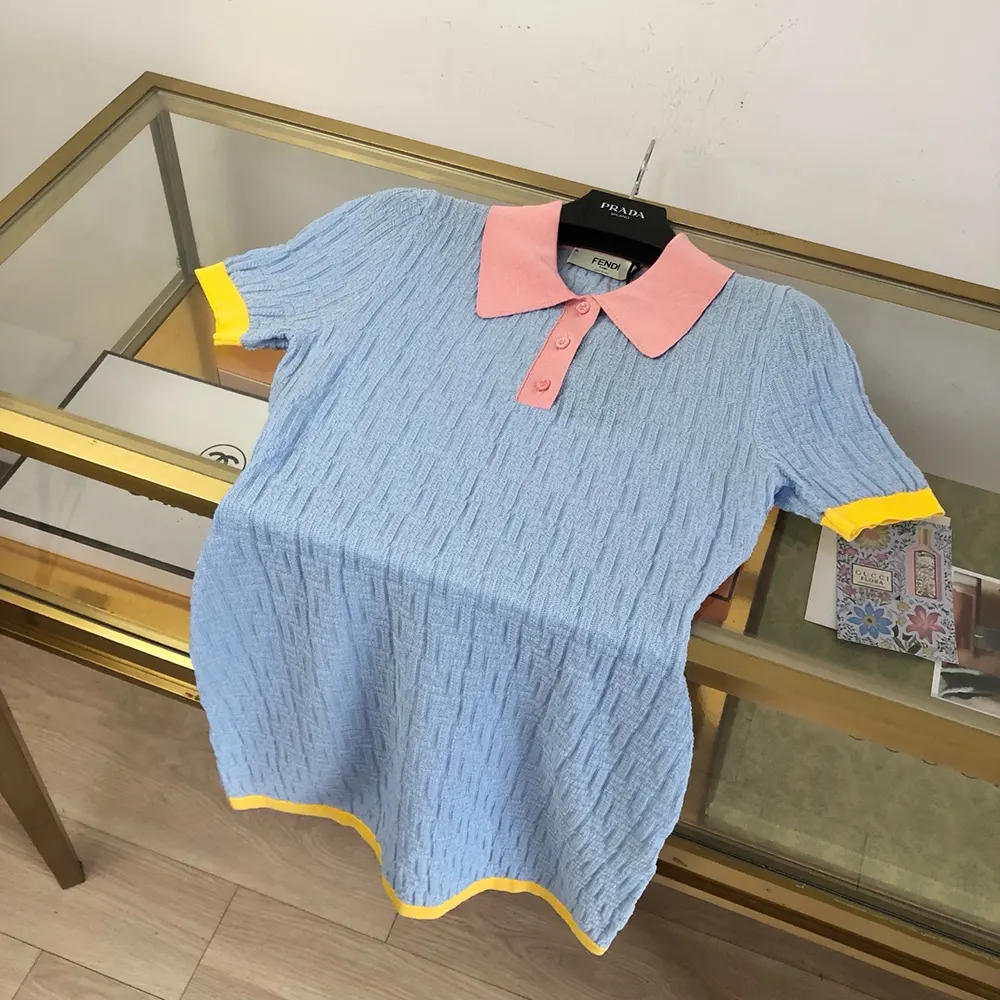 Close-up of Fendi FF logo pattern on blue cotton silk dress