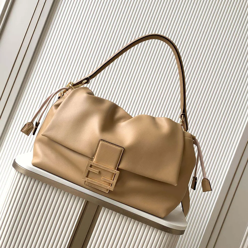 Close-up of gold hardware on Fendi Women Mamma Baguette Large Cappuccino Bag