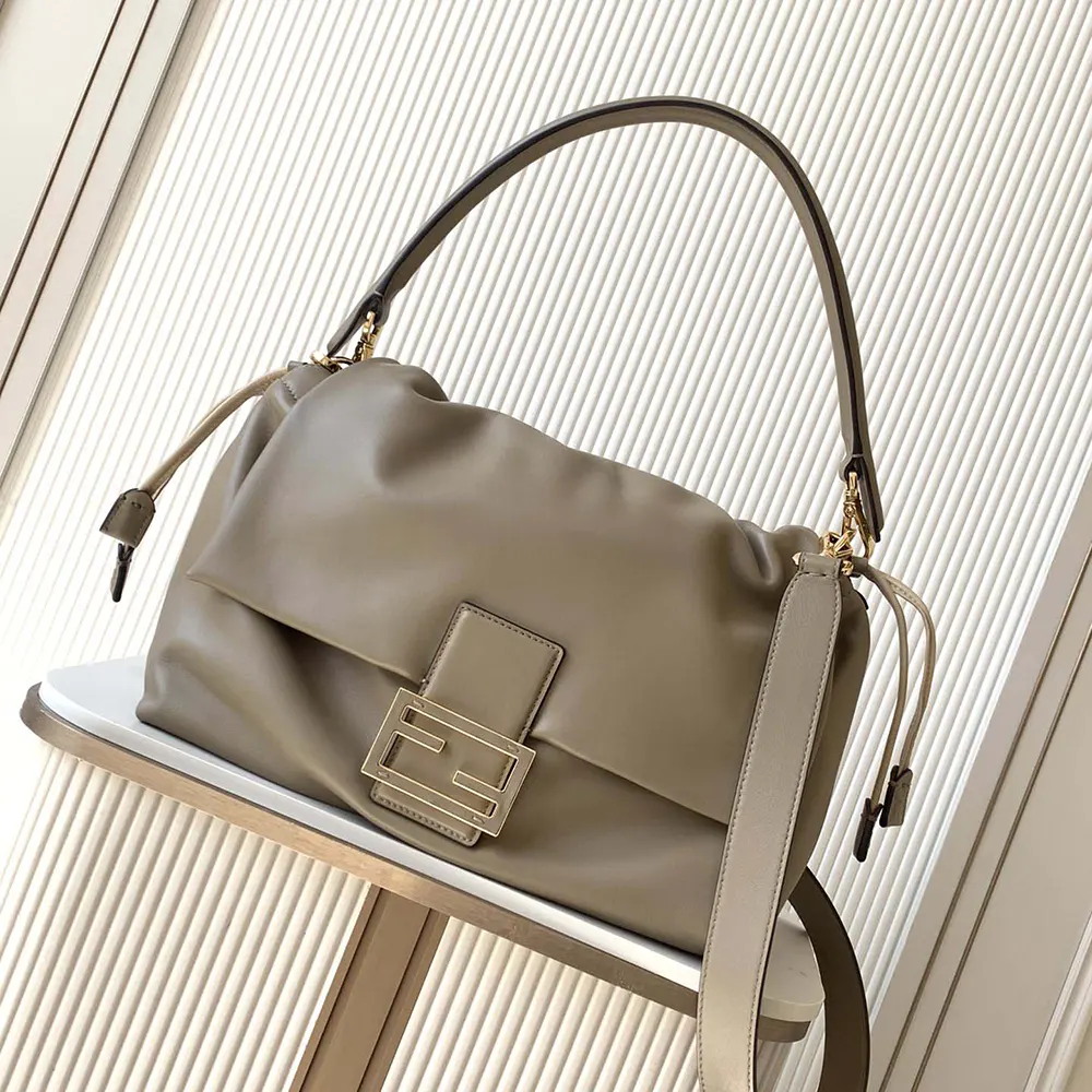Close-up on gold-tone hardware of Fendi Women Mamma Baguette Large Dove Gray Nappa Leather Bag