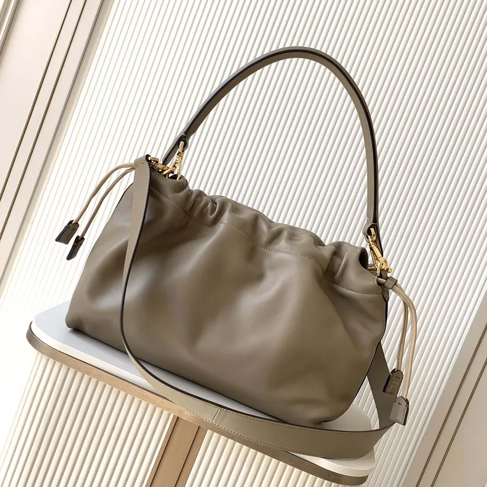 Side profile showing silhouette of Fendi Women Mamma Baguette Large Dove Gray Nappa Leather Bag