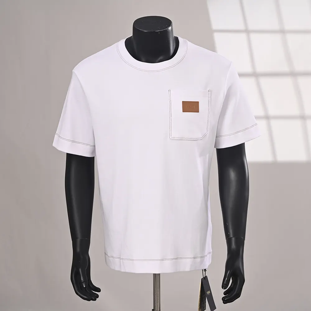 Close-up of Fendi logo embroidery on white cotton T-shirt sleeve