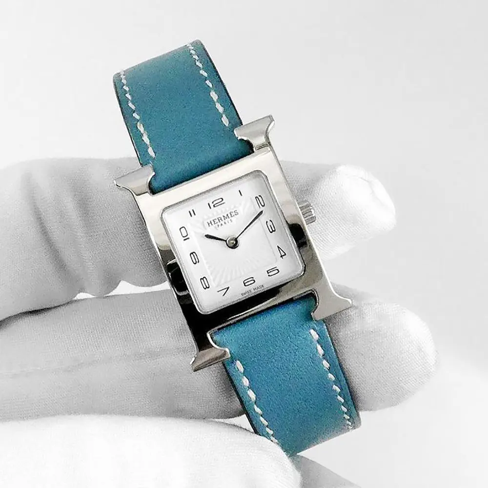 Side profile showing blue calfskin strap and stainless steel case of Hermes watch