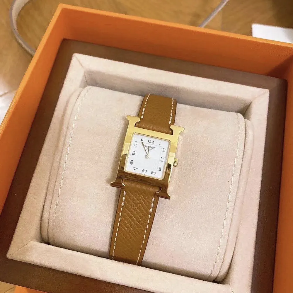 Close-up on signature H-shaped bezel of Hermes Women Heure H Watch Mini Model