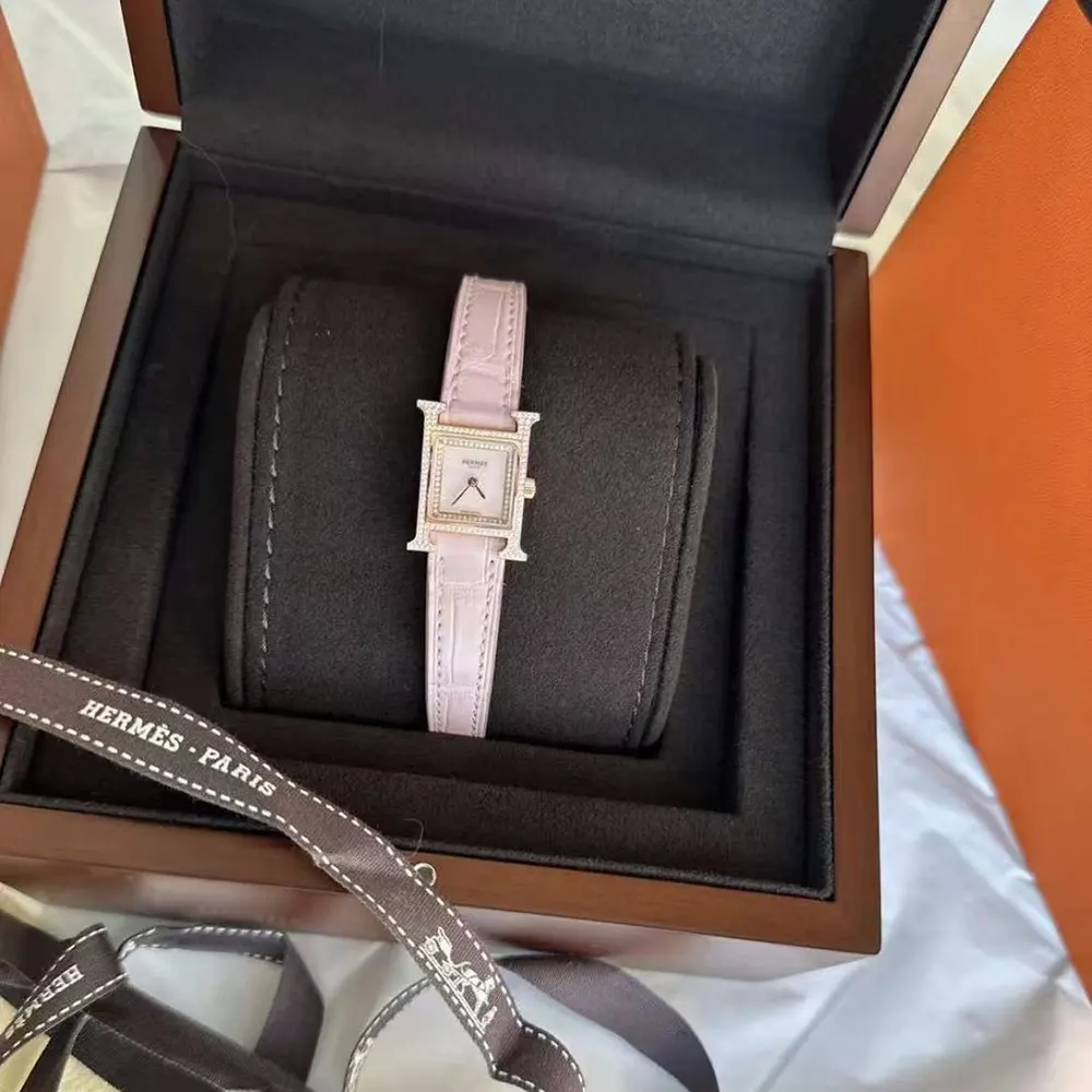 Close-up on pink leather strap and rose gold buckle of Hermes watch