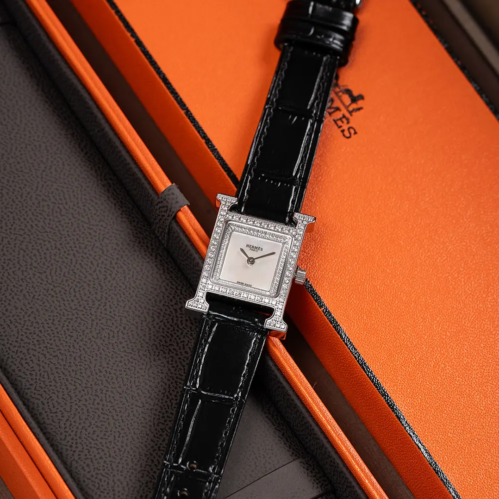 Side angle showing slim profile and polished case of Hermes Heure H watch