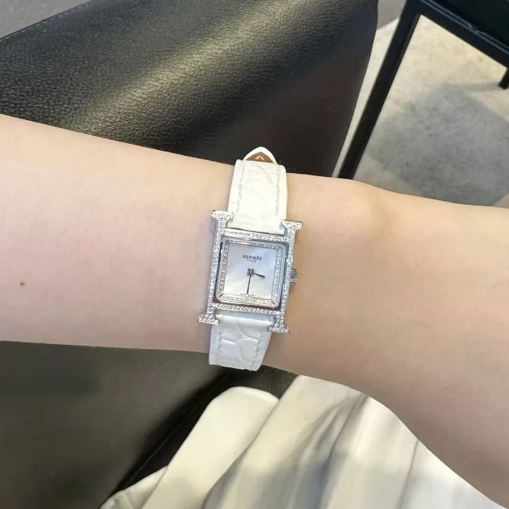 Side angle showing white leather strap and buckle of Hermes Women Heure H Watch Mini Model